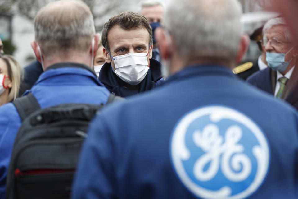 French President Emmanuel Macron meets worker as he visits the GE Steam Power System main production site for its nuclear turbine systems in Belfort, eastern France, Thursday, Feb. 10, 2022. French President Emmanuel Macron is to unveil plans to build new nuclear reactors in the country as part of its energy strategy to reduce planet-warming emissions. (AP Photo/Jean-Francois Badias, Pool)