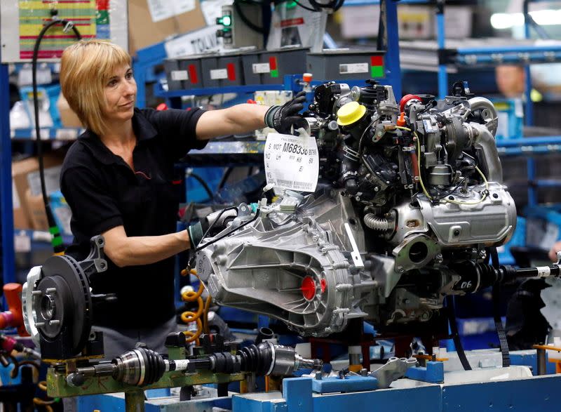 FILE PHOTO: A Nissan Motor staff works on an engine in the assembly line at the Zona Franca Nissan factory near Barcelona