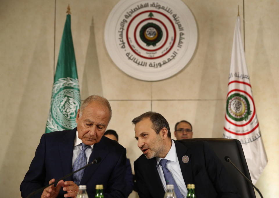 Lebanese Prime Minister Gibran Bassil, right, speaks with Arab League Secretary-General, Ahmed Aboul Gheit, left, during the opening session of the Arab foreign ministers meeting ahead of a weekend Arab Economic Summit, in Beirut, Lebanon, Friday, Jan. 18, 2019. The Arab Economic and Social Development Summit, or AESD, is being held in Lebanon for the first time amid sharp divisions in the country and among Arab countries. (AP Photo/Hussein Malla)