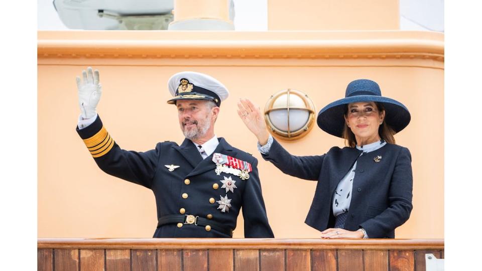 King Frederik and Queen Mary wave from the Royal Ship Dannebrog