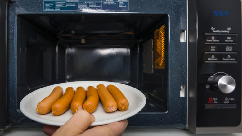 sausages going into microwave