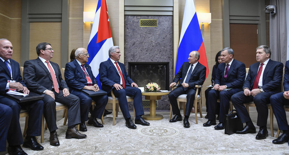 Russian President Vladimir Putin, center right, and Cuban President Miguel Diaz-Canel, center left, talk during their meeting at the Novo-Ogaryovo residence outside Moscow, Russia, Tuesday, Oct. 29, 2019. Putin hailed Cuba's resilience in the face of the U.S. pressure as he hosted Diaz-Canel for talks on expanding cooperation between the old allies. (Alexander Nemenov/Pool Photo via AP)