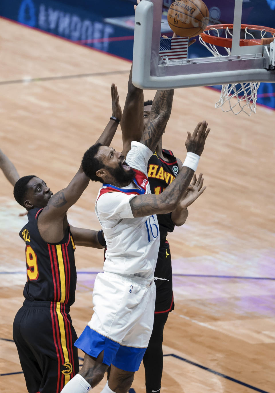 New Orleans Pelicans forward James Johnson (16) shoots over Atlanta Hawks forward Tony Snell (19) and forward Onyeka Okongwu (17) in the third quarter of an NBA basketball game in New Orleans, Friday, April 2, 2021. (AP Photo/Derick Hingle)