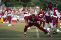 Washington Commanders defensive end Chase Young warms up during an NFL football practice at the team's training facility, Wednesday, Aug. 2, 2023, in Ashburn, Va. (AP Photo/Evan Vucci)