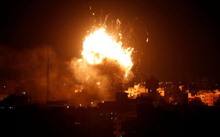 An explosion is seen during an Israeli air strike on Hamas's television station, in Gaza City November 12, 2018. REUTERS/Ahmed Zakot