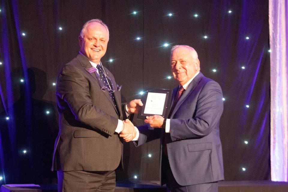 Andy Marshall, Chief Executive Officer and President of First Bank Southwest, presents Vance Reed with the 2022 AGN Man of the Year award at the awards luncheon Wednesday at the Amarillo Civic Center.