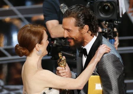 Julianne Moore accepts the Oscar for Best Leading Actress for her role in "Still Alice" from Matthew McConaughey at the 87th Academy Awards in Hollywood, California February 22, 2015. REUTERS/Mike Blake