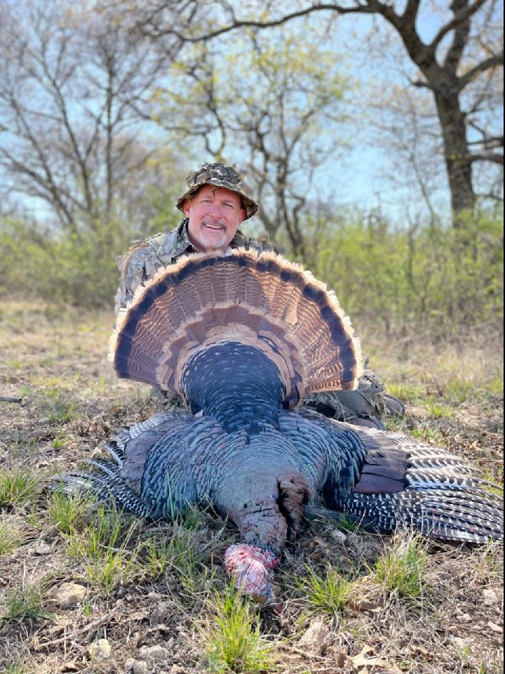 Brian Wooldridge with a Rio Grande turkey he hunted in Texas in 2022.