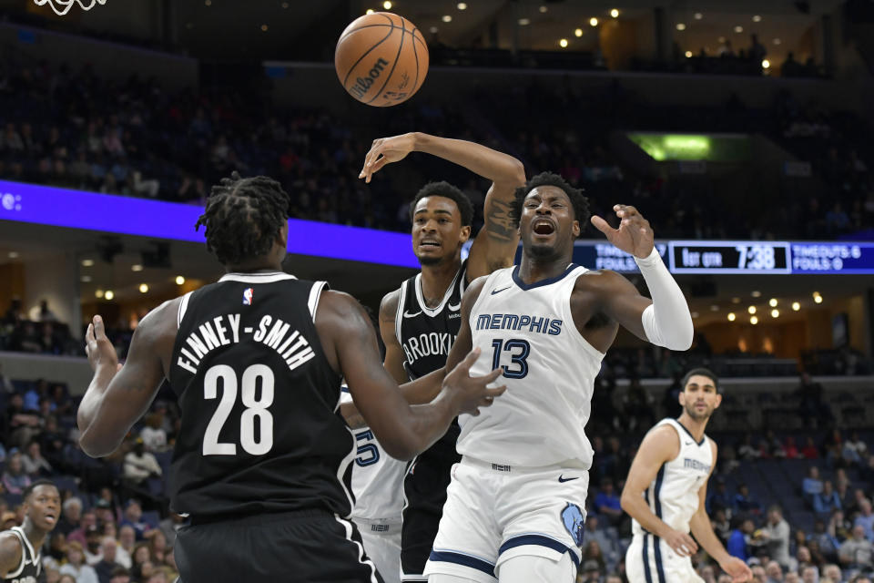 Memphis Grizzlies forward Jaren Jackson Jr. (13), Brooklyn Nets forward Dorian Finney-Smith (28) and center Nic Claxton move for the ball in the first half of an NBA basketball game Monday, Feb. 26, 2024, in Memphis, Tenn. (AP Photo/Brandon Dill)