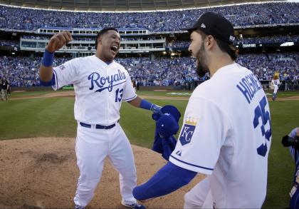 Jarrod Dyson and Lorenzo Cain celebrate with teammate Eric Hosmer