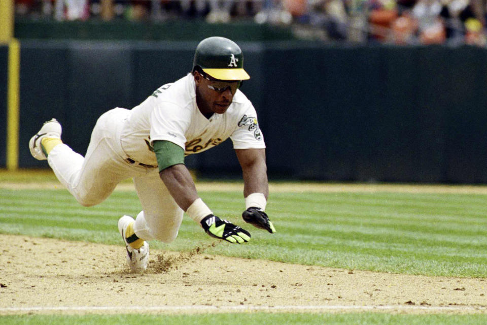 FILE - Oakland Athletics' Rickey Henderson dives for third base to steal his 939th career base to set the all-time stolen base record during the fourth inning of a baseball game against the New York Yankees, May 1, 1991, in Oakland. (AP Photo/Eric Risberg, File)