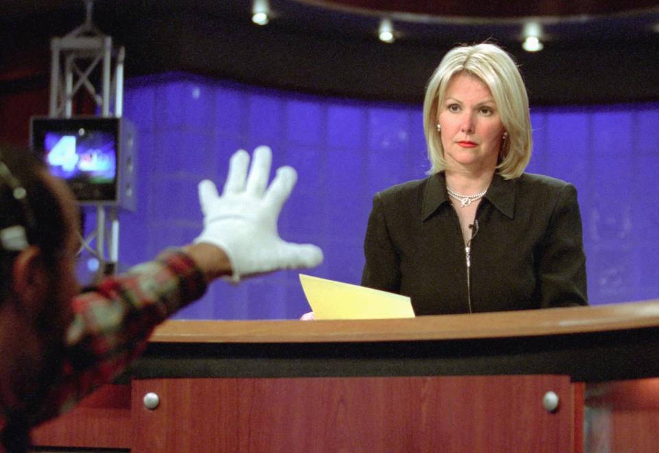 TV/Rieger 06/4/03 Susan Biddle/TWP Wendy Rieger is a WRC news anchor, broadcasting the news at 5:00pm from NBC's offices on Nebraska Ave. On the set Wendy at left watches Moe Javins who holds up his white gloved hand (to make it easier for the anchors to see) to indicate when she starts speaking and to which camera. At right is co anchor Susan Kidd. (Photo by Susan Biddle/The The Washington Post via Getty Images)