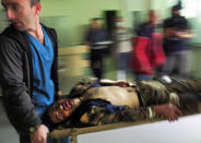 Medical workers transport a wounded in a hospital during shelling by Azerbaijan's artillery in Stepanakert, the separatist region of Nagorno-Karabakh, Wednesday, Oct. 28, 2020. Nagorno-Karabakh officials said Azerbaijani forces hit Stepanakert, the region's capital, and the nearby town of Shushi with the Smerch long-range multiple rocket systems, killing one civilian and wounding two more. (AP Photo)