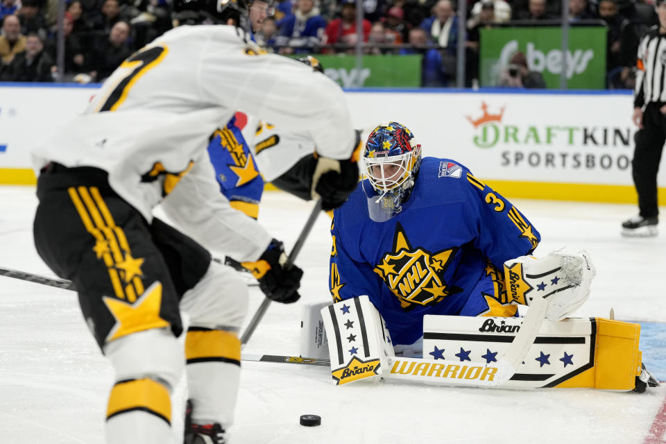 NHL All-Star Team Matthews goaltender Igor Shesterkin (31), of the New York Rangers, stops NHL All-Star Team McDavid captain forward Connor McDavid, left, of the Edmonton Oilers, during the NHL All-Star Game 3-on-3 hockey tournament in Toronto, Ontario, Saturday, Feb. 3, 2024. (Frank Gunn/The Canadian Press via AP)