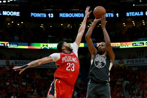 Kevin Durant (R) of the Golden State Warriors shoots against Anthony Davis of the New Orleans Pelicans