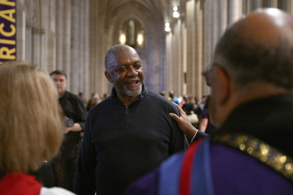 Artist Kerry James Marshall, center, speaks to attendees after an unveiling and dedication ceremony at the Washington National Cathedral for the new stained-glass windows with a theme of racial justice, Saturday, Sept. 23, 2023, in Washington. The new windows, titled “Now and Forever," are based on a design by Marshall. Marshall, who was born in Birmingham in 1955, invited anyone viewing the new windows, or other artworks inspired by social justice, “to imagine oneself as a subject and an author of a never-ending story is that is still yet to be told.” (AP Photo/Nick Wass)