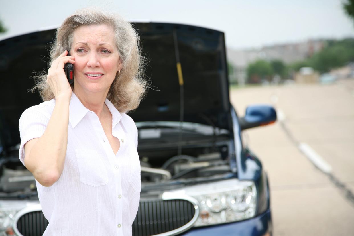 worried senior calling for help with her car