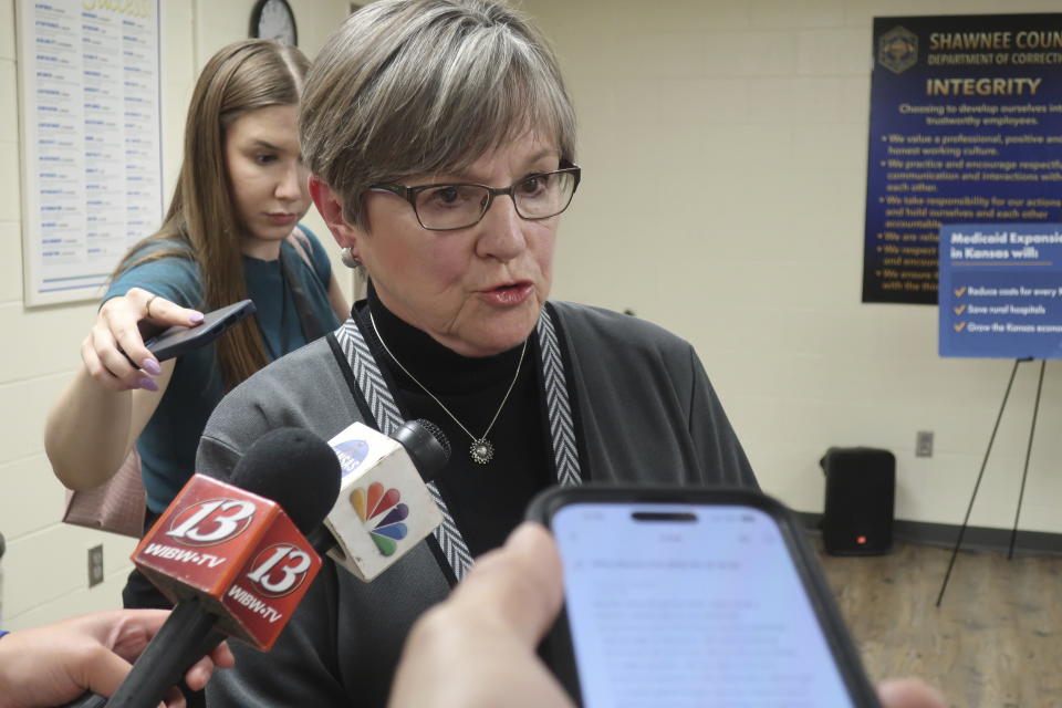 Kansas Gov. Laura Kelly answers questions from reporters following a public event at the Shawnee County, Kansas, jail, Tuesday, April 16, 2024, in Topeka, Kan. Kelly has vetoed provisions included by Republican lawmakers in the next state budget to force her to assist Texas in its fight with the Biden administration over border security. (AP Photo/John Hanna)