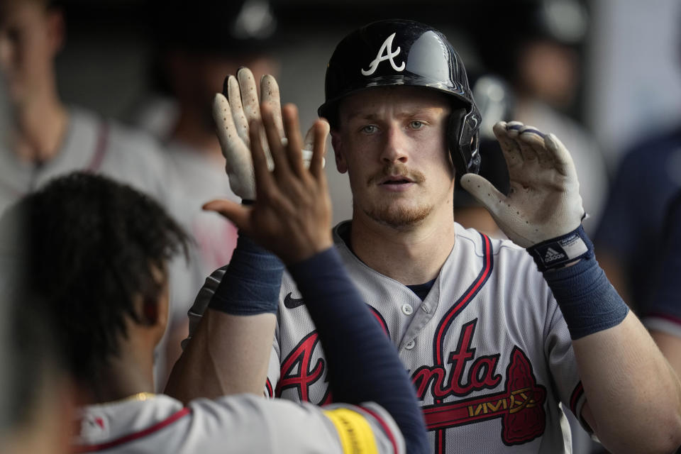 Atlanta Braves' Sean Murphy gets high-fives in the dugout after hitting a home run against the Cleveland Guardians during the third inning of a baseball game Wednesday, July 5, 2023, in Cleveland. (AP Photo/Sue Ogrocki)