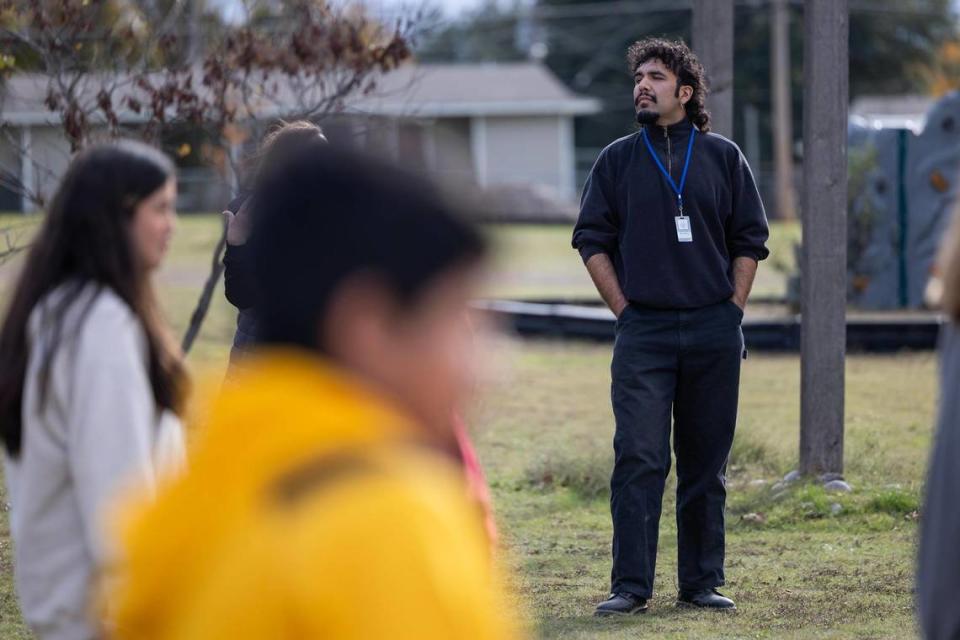 Omar Marquez, a restorative practices coach, watches over his students while they play outside at Applied Learning Academy in Fort Worth on Wednesday, Nov. 29, 2023. When a student gets in trouble, Marquez coaches them about how they were in the wrong, how it affected other people and how they can make it right.