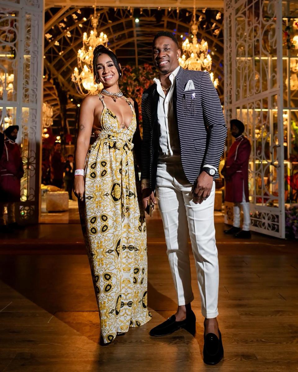 This handout photograph taken and released by Reliance on March 1, 2024, shows West Indies's former cricket captain Dwayne Bravo (R) attending a three-day pre-wedding celebration hosted by billionaire tycoon Mukesh Ambani, for his son Anant Ambani and Radhika Merchant in Jamnagar.
