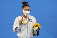 Sunisa Lee of the Unites States displays her gold medal for the artistic gymnastics women's all-around at the 2020 Summer Olympics, Thursday, July 29, 2021, in Tokyo. (AP Photo/Natacha Pisarenko)