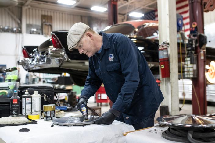 Owner Bill Jagenow buffs a wheel cap at the Brothers Custom Automotive in Troy on March 1, 2022.