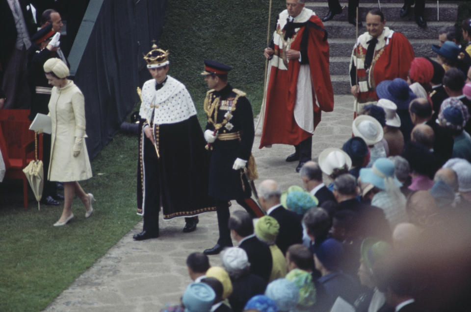 Prince Charles (centre, left) leaving the Upper Ward of Caernarfon Castle after the ceremony of Charles' investiture as Prince of Wales, Gwynedd, Wales, 1st July 1969. With him are Queen Elizabeth II and Prince Philip. (Photo by Fox Photos/Hulton Archive/Getty Images)