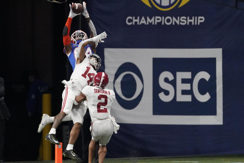 Florida tight end Kyle Pitts (84) makes a touchdown catch against Alabama defensive back Brian Branch (14) during the second half of the Southeastern Conference championship NCAA college football game, Saturday, Dec. 19, 2020, in Atlanta. (AP Photo/John Bazemore)