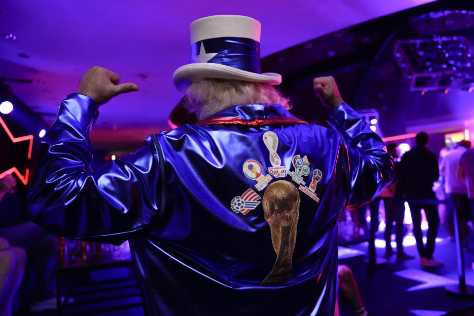 Hector Garcia, 59, of Glendale Heights, Illinois, shows off his jacket, which displays the five FIFA World Cup tournaments he has attended, during an official U.S. Soccer fan party at the FIFA World Club ahead of a group B soccer match between the United States and Wales, in Doha, Sunday, Nov. 20, 2022. He plans to attend 28 games during the 2022 FIFA World Cup. (AP Photo/Ashley Landis)