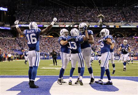 Jan 4, 2014; Indianapolis, IN, USA; Indianapolis Colts wide receiver T.Y. Hilton (13) is congratulated by teammates after scoring the winning touchdown against the Kansas City Chiefs in the fourth quarter during the 2013 AFC wild card playoff football game at Lucas Oil Stadium. Indianapolis defeats Kansas City 45-44. Mandatory Credit: Brian Spurlock-USA TODAY Sports