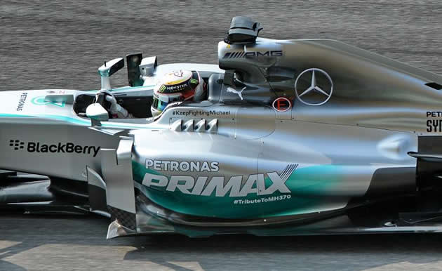 Lewis Hamilton's race car bears a tribute to flight MH370, alongside one to Michael Schumacher. (AFP photo)