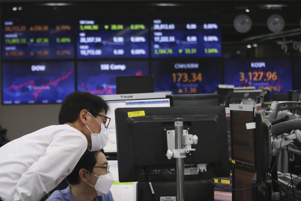 Currency traders watch monitors at the foreign exchange dealing room of the KEB Hana Bank headquarters in Seoul, South Korea, Tuesday, May 4, 2021. Asian shares were mixed Tuesday after strong corporate earnings and economic data lifted stocks on Wall Street. (AP Photo/Ahn Young-joon)