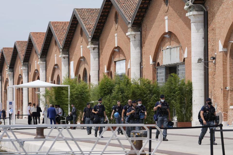 Policemen walk to embark on a boat at the Arsenale, during a G20 meeting of Economy and Finance ministers and Central bank governors in Venice, Italy, Thursday, July 8, 2021. (AP Photo/Luca Bruno)