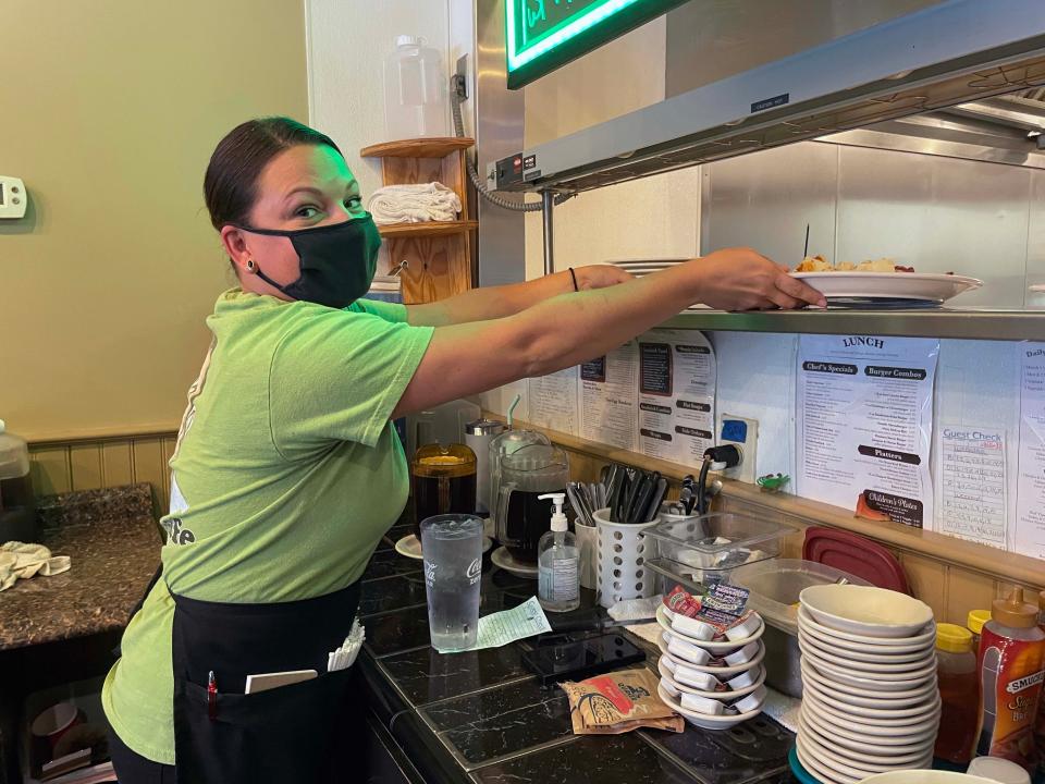 No sooner does owner Bassam Natour place a breakfast plate under the warmer than Amanda Hosea retrieves it for her customer at Sami’s Café, 9700 Kingston Pike, Tuesday, July 5, 2022.