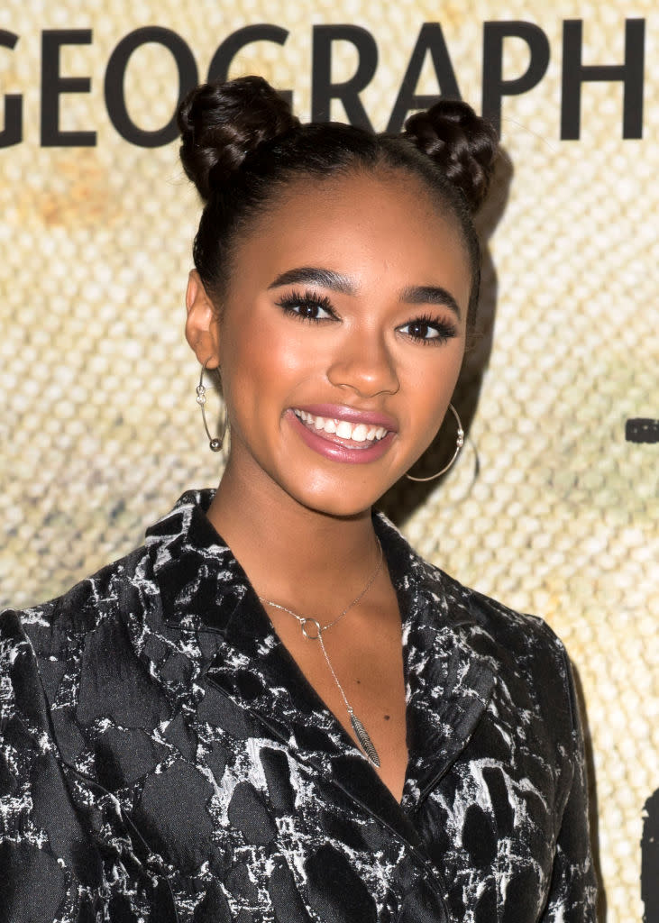 <p>The 17-year-old rising actress kept her hair and makeup fun, wearing braided topknots, groomed brows, and light pink lipstick. (Photo: Getty Images) </p>