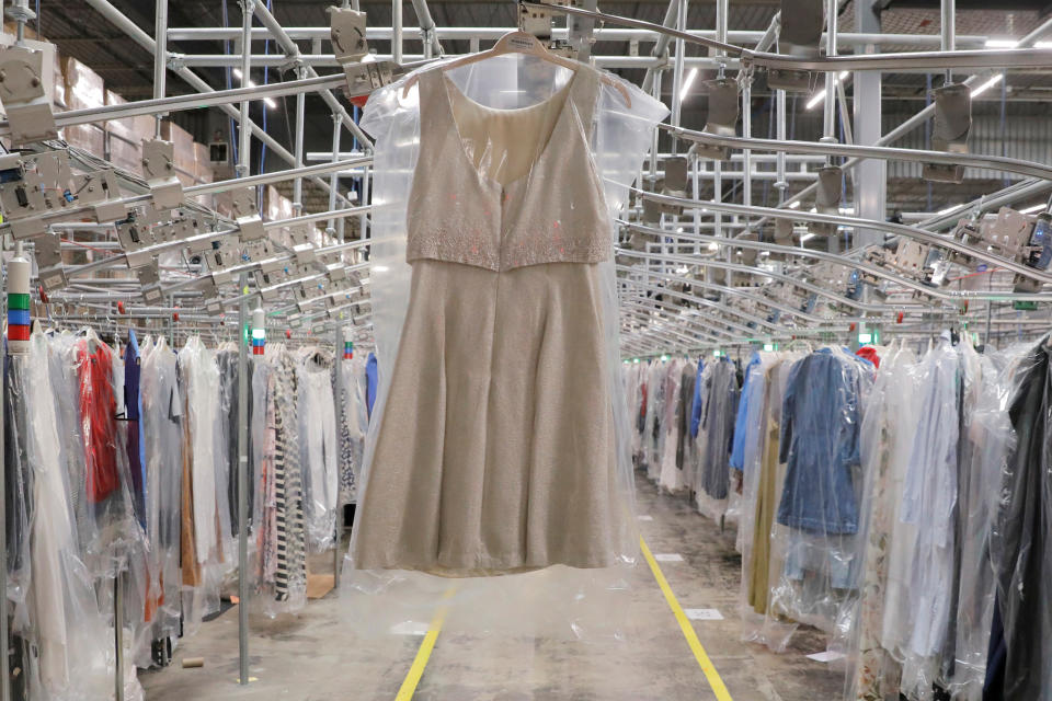 A garment hangs in the automated sortation section at Rent the Runway's 