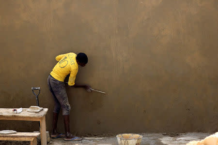 A mason is seen doing plastering works on a school wall in Damasak, Borno, Nigeria April 25, 2017. Picture taken April 25, 2017. REUTERS/Afolabi Sotunde