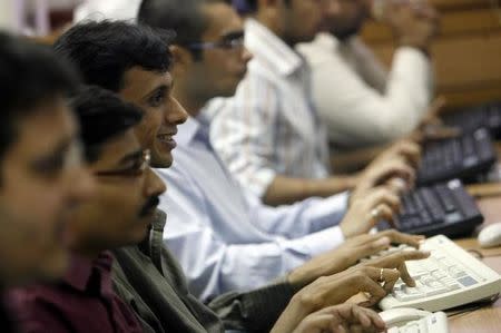 Brokers trade at a stock brokerage firm in Mumbai July 9, 2008. REUTERS/Arko Datta/Files