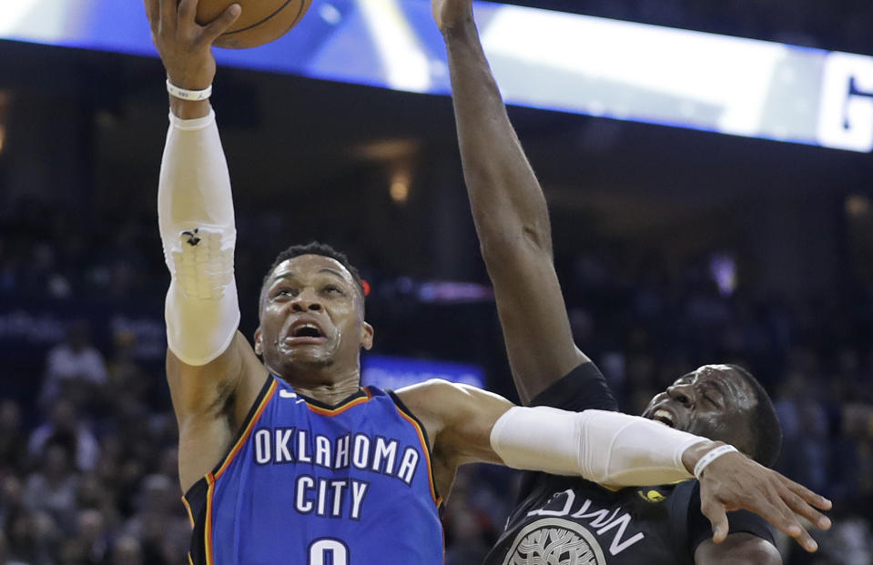 Thunder star Russell Westbrook catches Warriors forward with an elbow on his way to the basket. (AP)