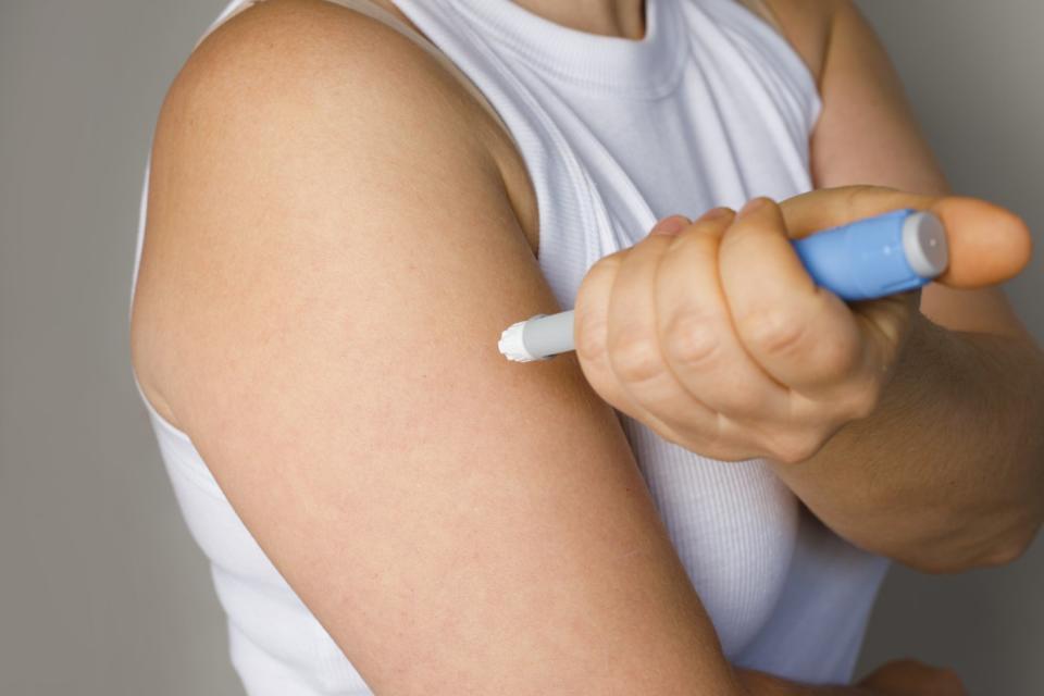 A person using a GLP-1 injection pen.