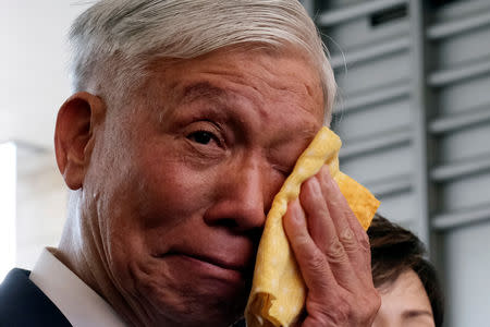 Occupy Central pro-democracy movement founder Chu Yiu-ming cries as he speaks to the media after getting his suspended sentence on his involvement in the Occupy Central, also known as "Umbrella Movement", in Hong Kong, China April 24, 2019. REUTERS/Tyrone Siu