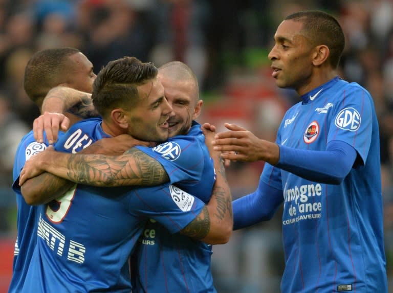 From L: Caen's forward Andy Delort celebrates with midfielder Vincent Bessat, and forward Sylvio Ronny Rodelin, after scoring a goal during a French L1 football match against Saint Etienne on October 4, 2015