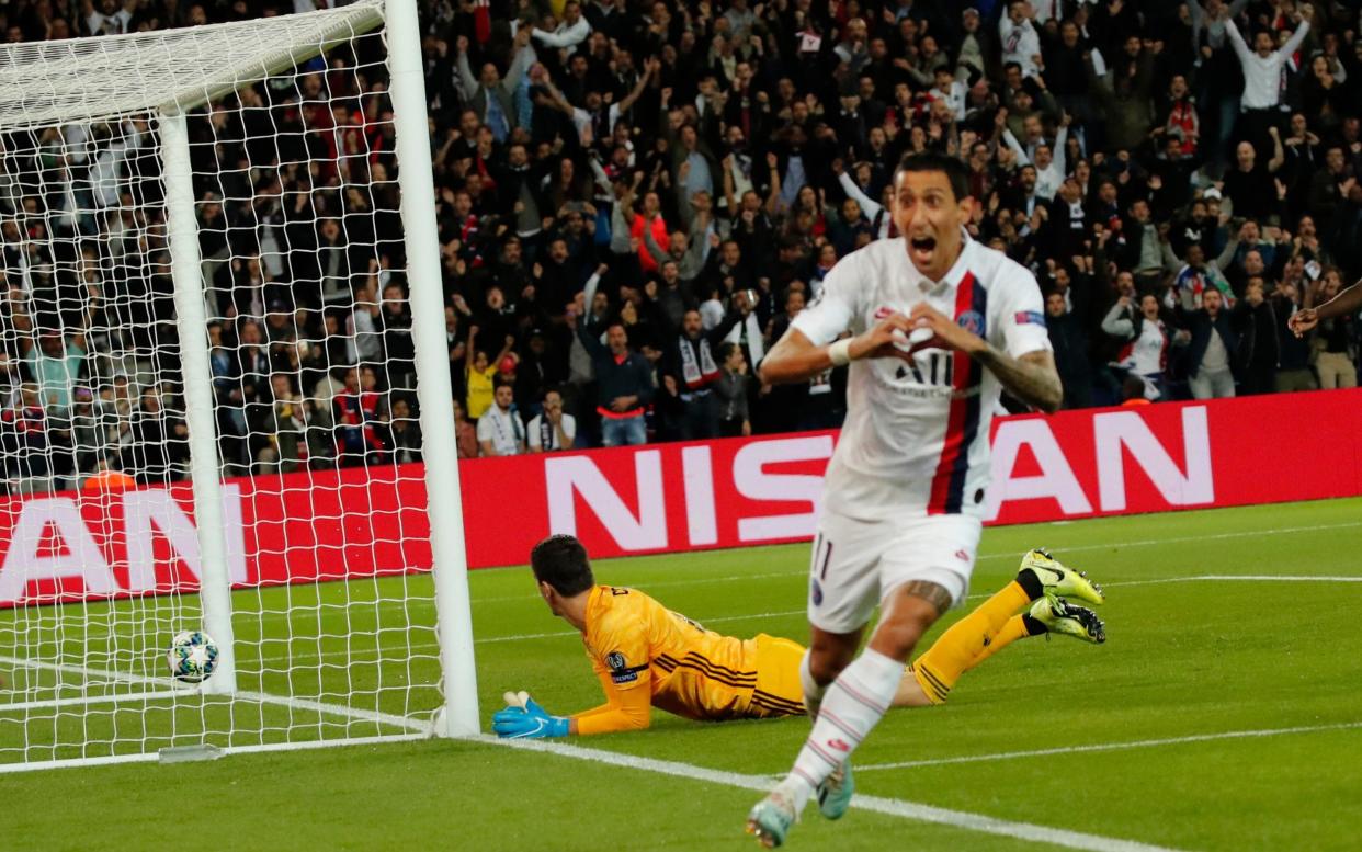 Real Madrid's goalkeeper Thibaut Courtois, bottom, fails to save the ball as PSG's Angel Di Maria celebrates after scoring his side's opening goal during the Champions League group A soccer match between PSG and Real Madrid  - AP