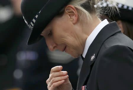 A police officer reacts outside Southwark Cathedral during the funeral of PC Keith Palmer, who was killed in the recent Westminster attack, in central London, Britain April 10, 2017. REUTERS/Peter Nicholls