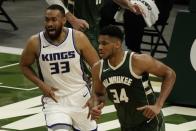 Sacramento Kings' Jabari Parker defends Milwaukee Bucks' Giannis Antetokounmpo during the first half of an NBA basketball game Sunday, Feb. 21, 2021, in Milwaukee. (AP Photo/Morry Gash)