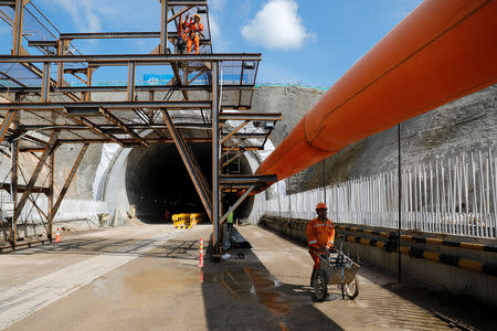 A worker pushes a wheelbarrow at Walini tunnel construction site for Jakarta-Bandung High Speed Railway in West Bandung regency, West Java province, Indonesia, February 21, 2019. REUTERS/Willy Kurniawan