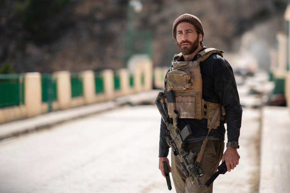 Jake Gyllenhaal in military gear holding a gun