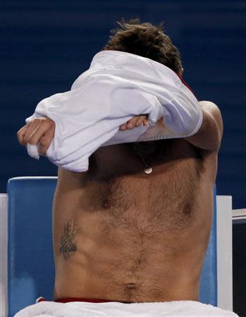 Stanislas Wawrinka of Switzerland changes his shirt during his men's singles semi-final match against Tomas Berdych of the Czech Republic at the Australian Open 2014 tennis tournament in Melbourne January 23, 2014. REUTERS/Jason Reed