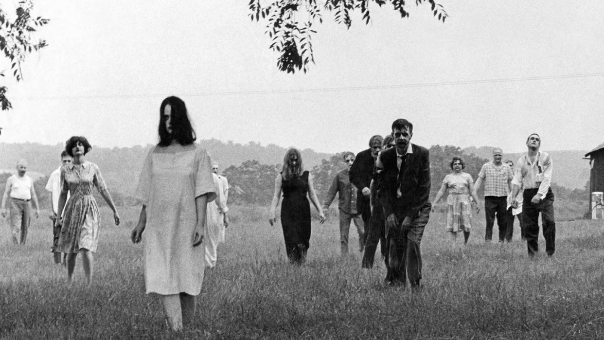 zombies walk across a field in a scene from night of the living dead, a good housekeeping pick for best halloween movies
